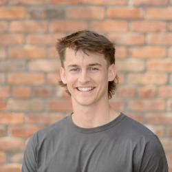 Tsavo Knott profile image: young man wearing a grey T-shirt